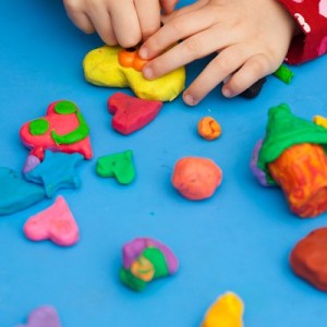 Child using play doh in play therapy