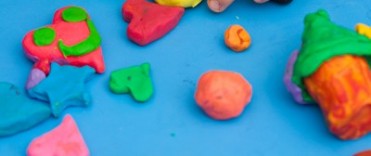 Child using play doh in play therapy